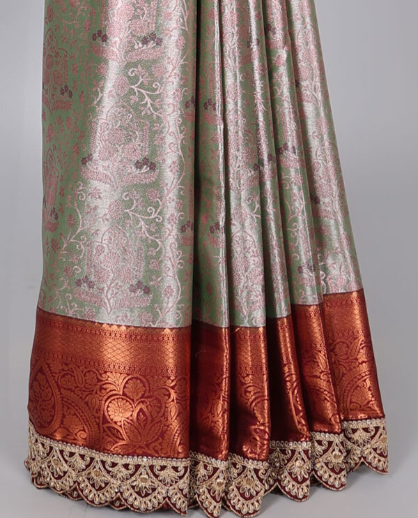 green semi tissue saree with patch embroidery border and floral motifs