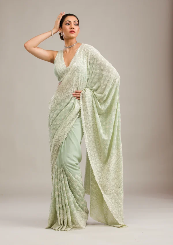 pista green georgette saree with intricate threadwork and embroidery