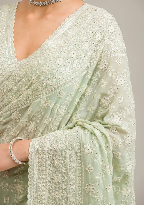 pista green georgette saree with intricate threadwork and embroidery