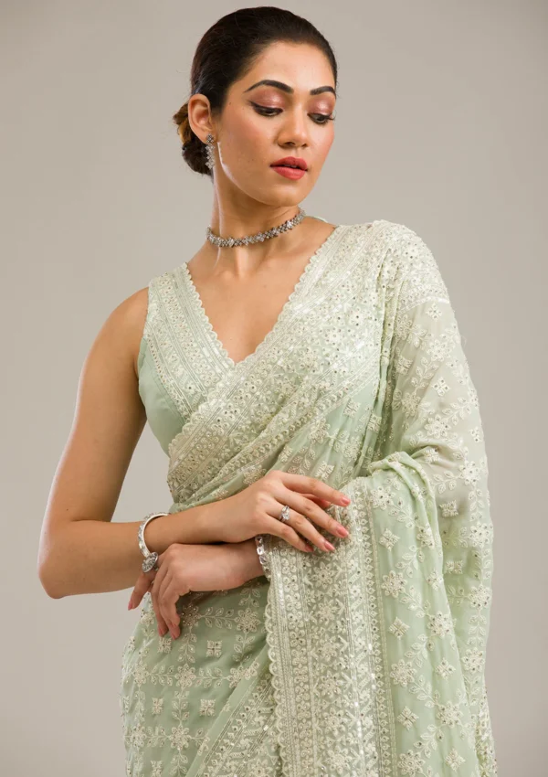 pista green georgette saree with intricate threadwork and embroidery