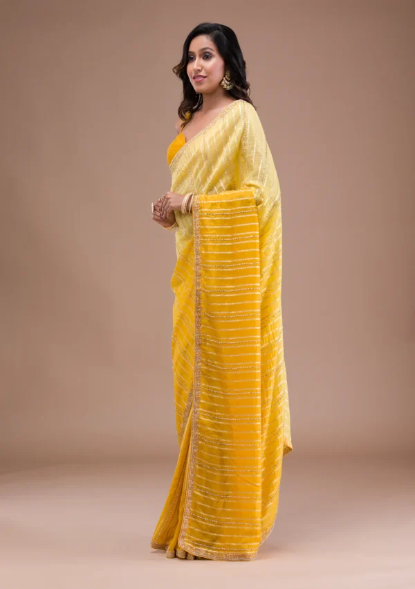 yellow organza saree with cutdana embroidery