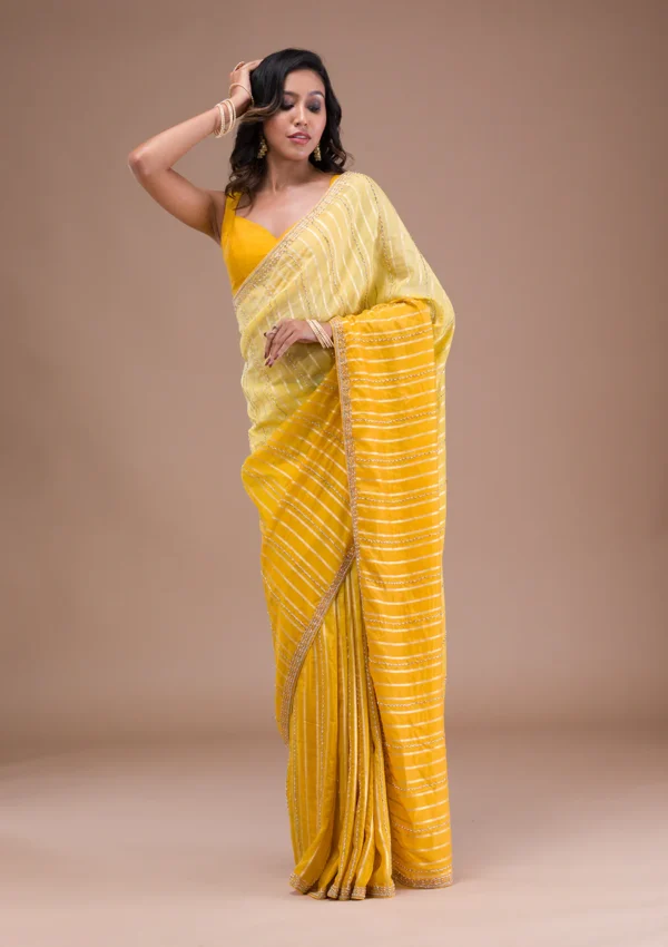 yellow organza saree with cutdana embroidery