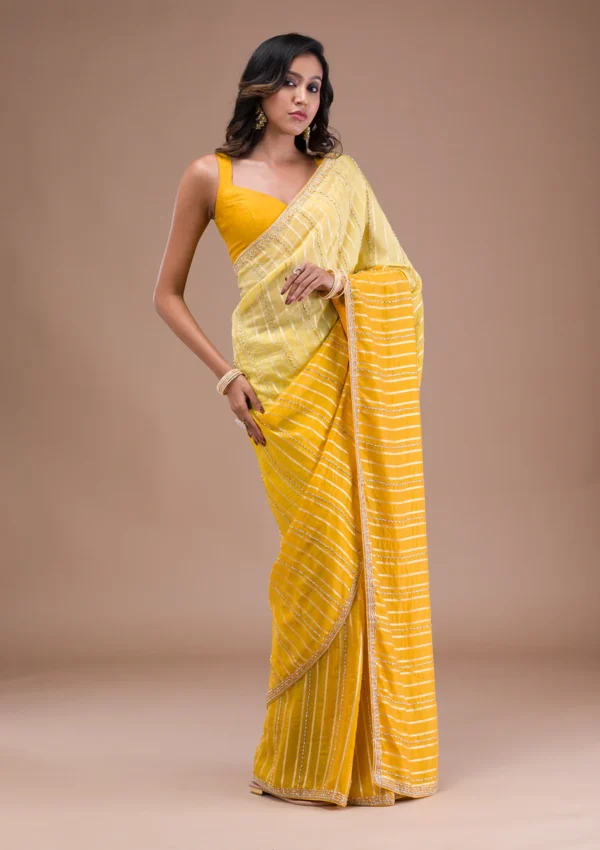 yellow organza saree with cutdana embroidery