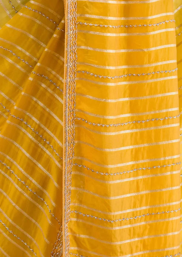 yellow organza saree with cutdana embroidery