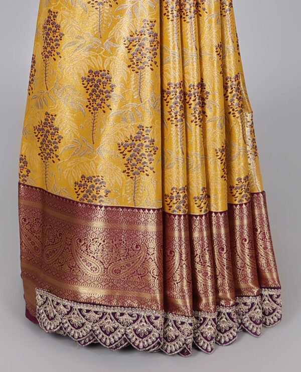 yellow semi tissue saree with patch work border and floral motifs